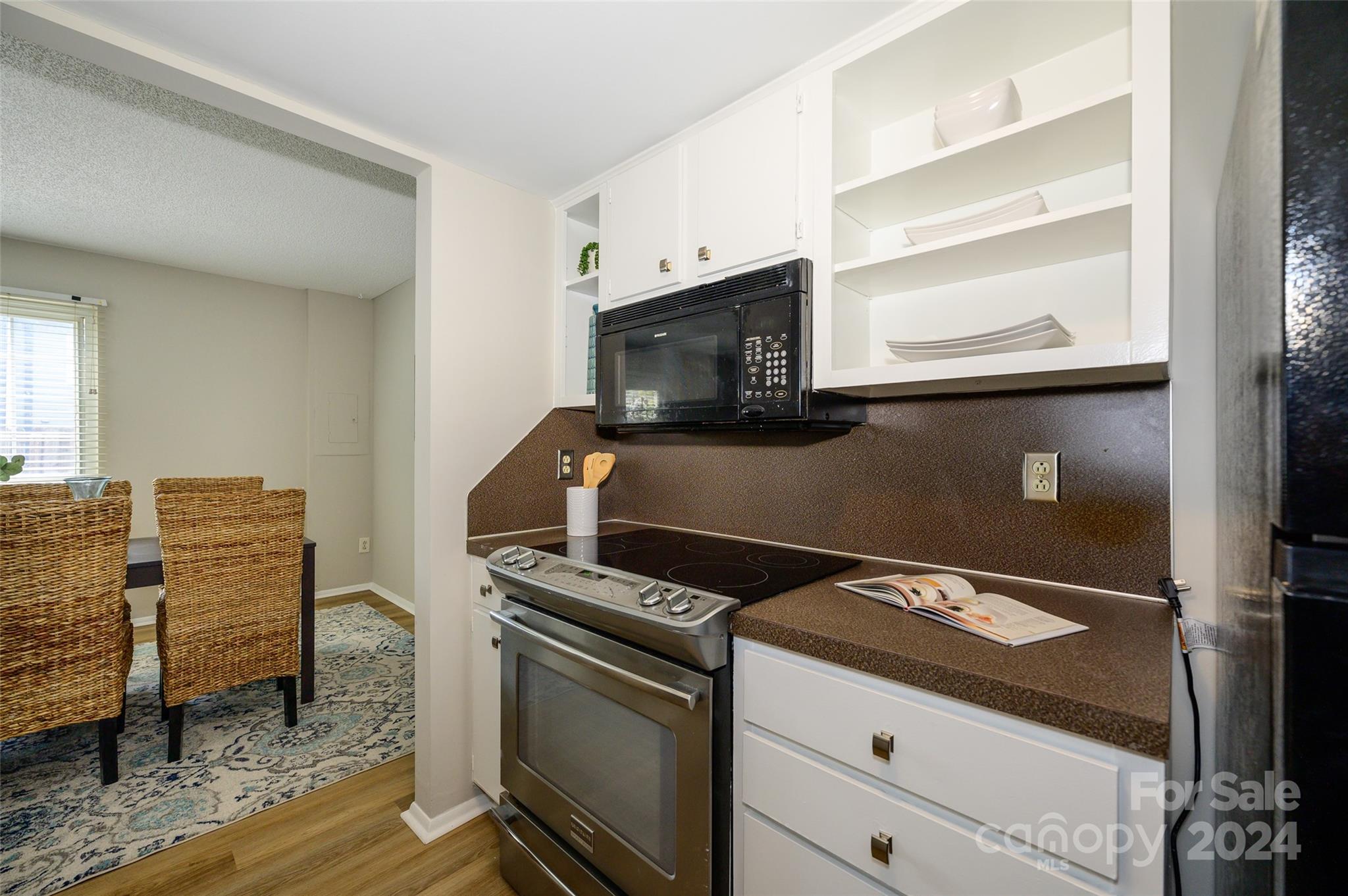 1211 Scaleybark Road, Unit B Charlotte, NC 28209 - Photo 10 of 30 a kitchen with granite countertop a stove and a microwave