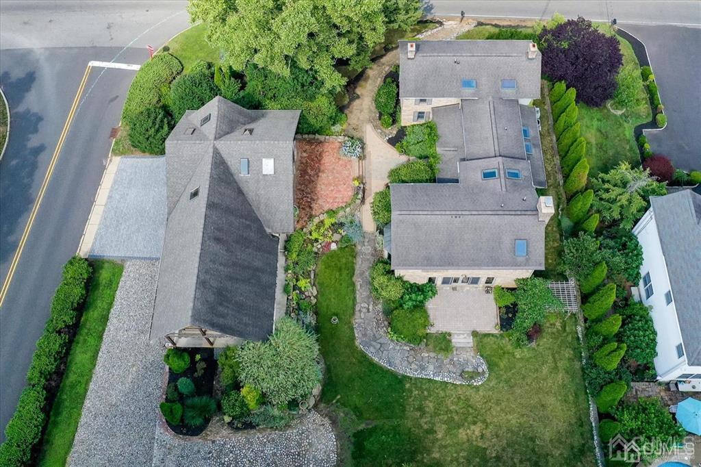 an aerial view of a house with a garden and a yard
