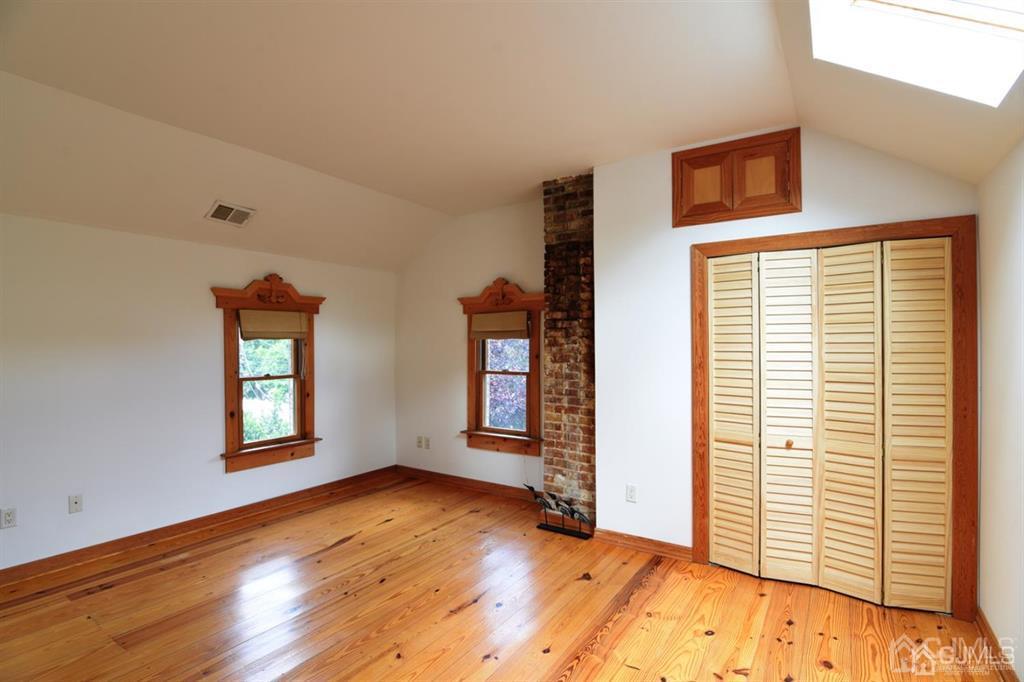 279 Cottrell Road Old Bridge, NJ 07747 - Photo 28 of 41 a view of an empty room with wooden floor and a window