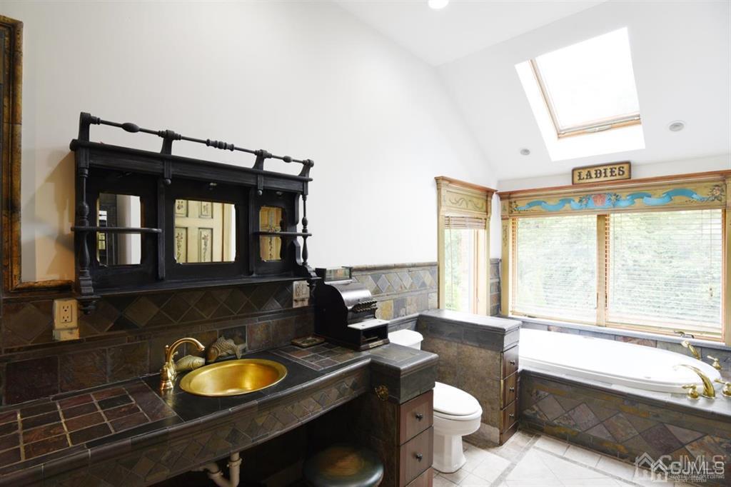 279 Cottrell Road Old Bridge, NJ 07747 - Photo 32 of 41 a bathroom with a sink a toilet and a mirror
