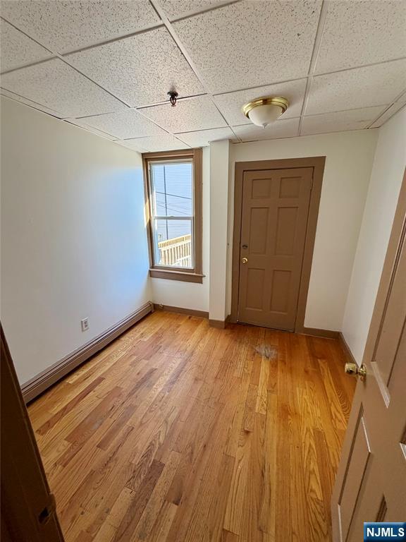 187 Main Street, Unit A Ridgefield Park, NJ 07660 - Photo 3 of 7 a view of an empty room with wooden floor and a window