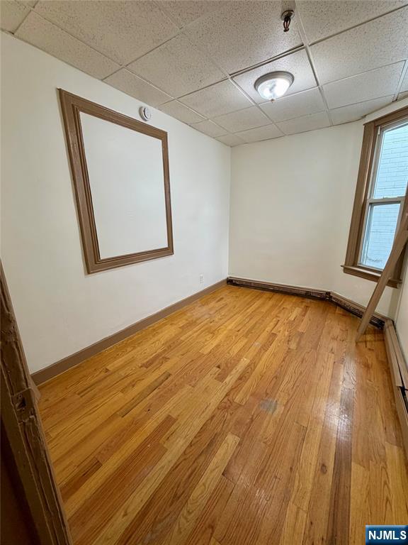 187 Main Street, Unit A Ridgefield Park, NJ 07660 - Photo 4 of 7 a view of an empty room with wooden floor and a window