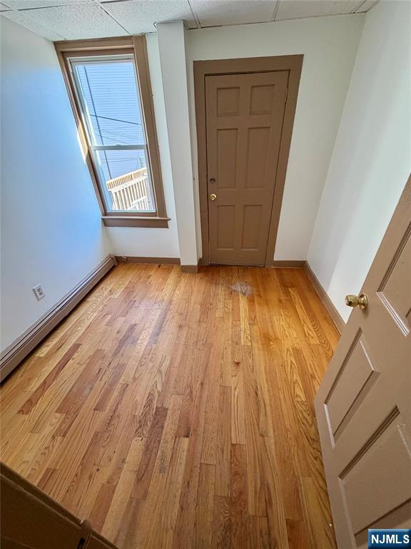 187 Main Street, Unit A Ridgefield Park, NJ 07660 - Photo 5 of 7 an empty room with wooden floor and windows