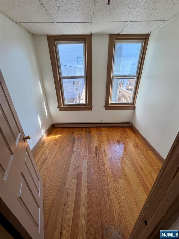 187 Main Street, Unit A Ridgefield Park, NJ 07660 - Photo 6 of 7 a view of an empty room with wooden floor and a window