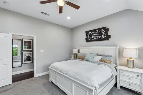 a bedroom with a bed and a night stand