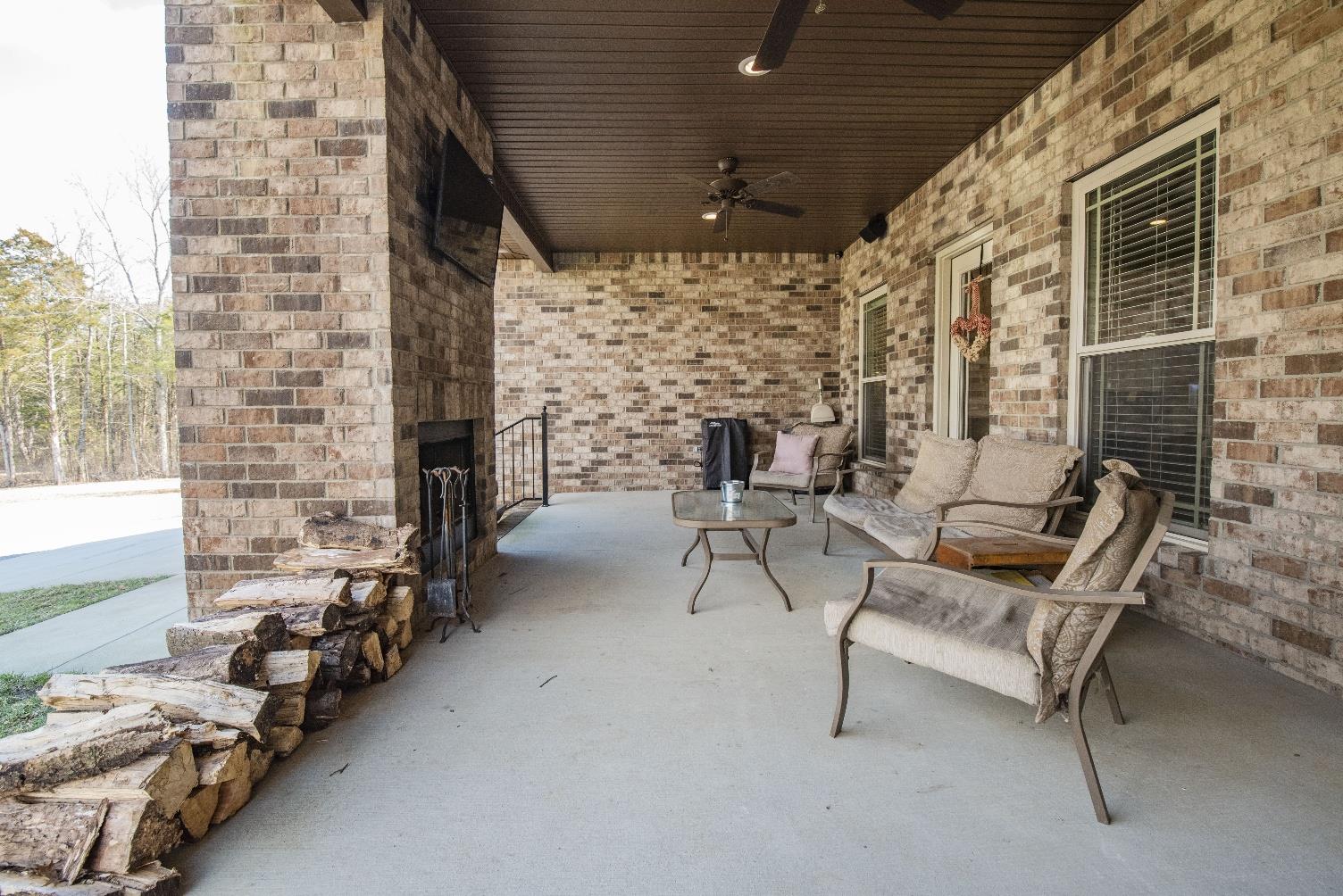 14780 Mt Pleasant Road Rockvale, TN 37153 - Photo 4 of 25 Enjoy a relaxing time on the covered back porch with wood burning fireplace and built in speakers.