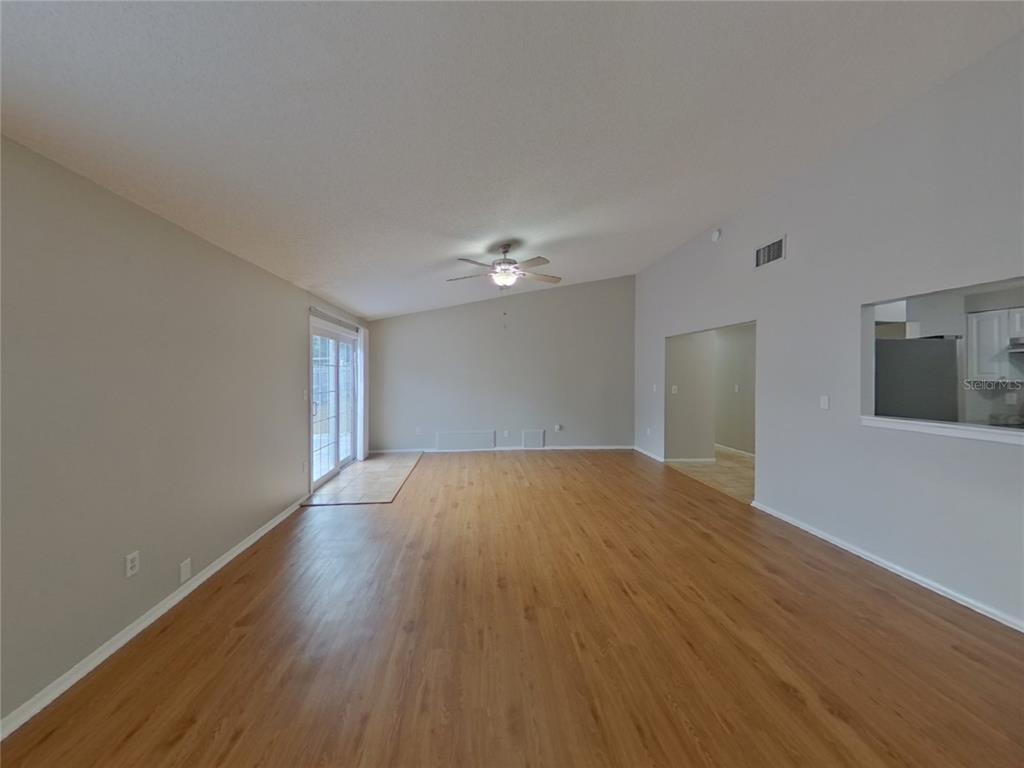 Undisclosed Address Palm Harbor, FL 34684 - Photo 2 of 15 a view of empty room with wooden floor