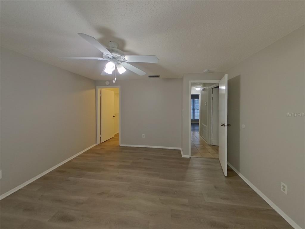 Undisclosed Address Palm Harbor, FL 34684 - Photo 7 of 15 an empty room with closet and a ceiling fan