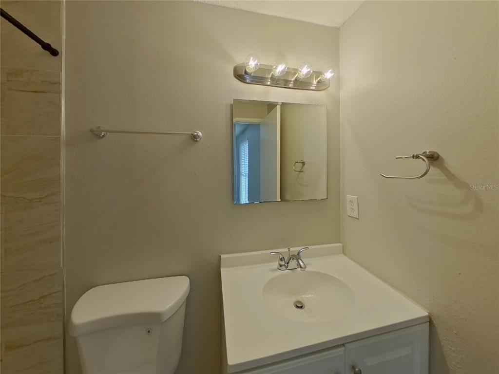Undisclosed Address Palm Harbor, FL 34684 - Photo 8 of 15 a bathroom with a sink a toilet and mirror