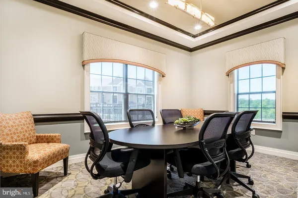 a view of a dining room with furniture and window