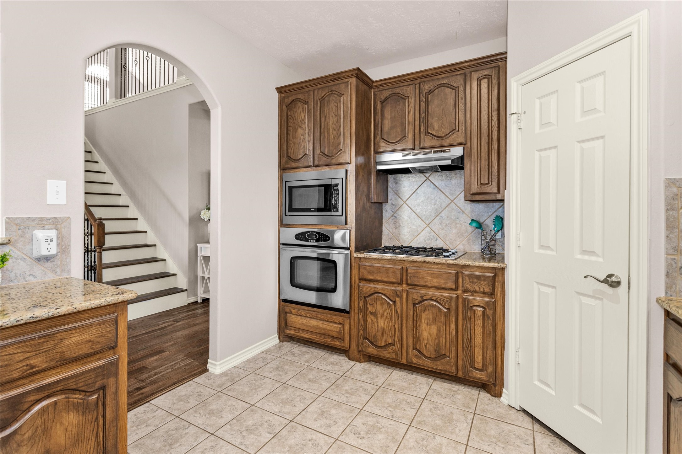 30110 Legends Ridge Drive Spring, TX 77386 - Photo 18 of 49 a kitchen with granite countertop a refrigerator and a stove top oven