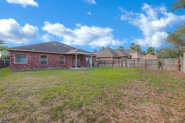 a view of a house with a backyard