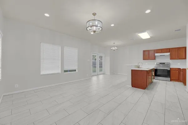 a view of kitchen with stainless steel appliances granite countertop lots of counter top space