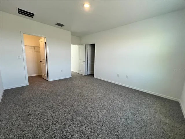 a en suite bathroom with a double vanity sink a toilet and a mirror