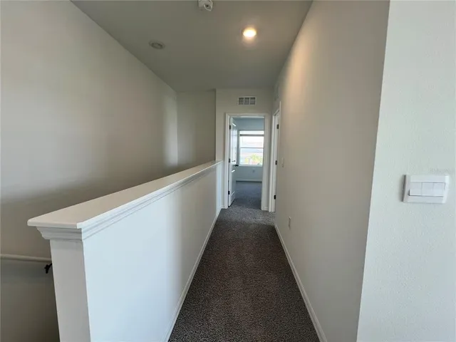 an empty room with a window and a fireplace