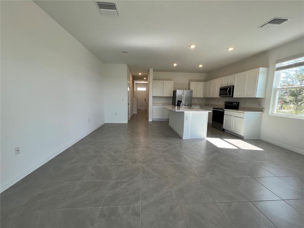 110 Mangrove Shade Circle Apollo Beach, FL 33572 - Photo 8 of 36 a view of a kitchen with a sink and microwave
