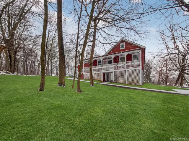 a grassy field with trees in the background