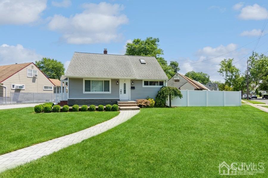 2 Colonial Road Roselle, NJ 07203 - Photo 1 of 17 a front view of a house with a garden and yard