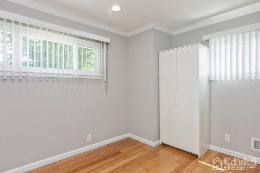 2 Colonial Road Roselle, NJ 07203 - Photo 11 of 17 a view of an empty room with wooden floor and a window