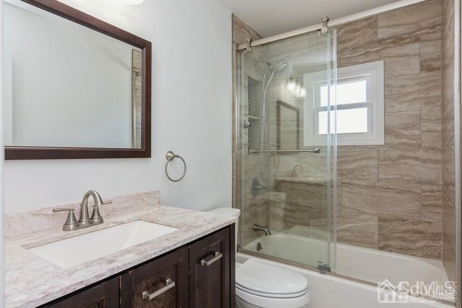 2 Colonial Road Roselle, NJ 07203 - Photo 12 of 17 a bathroom with a granite countertop sink toilet and shower