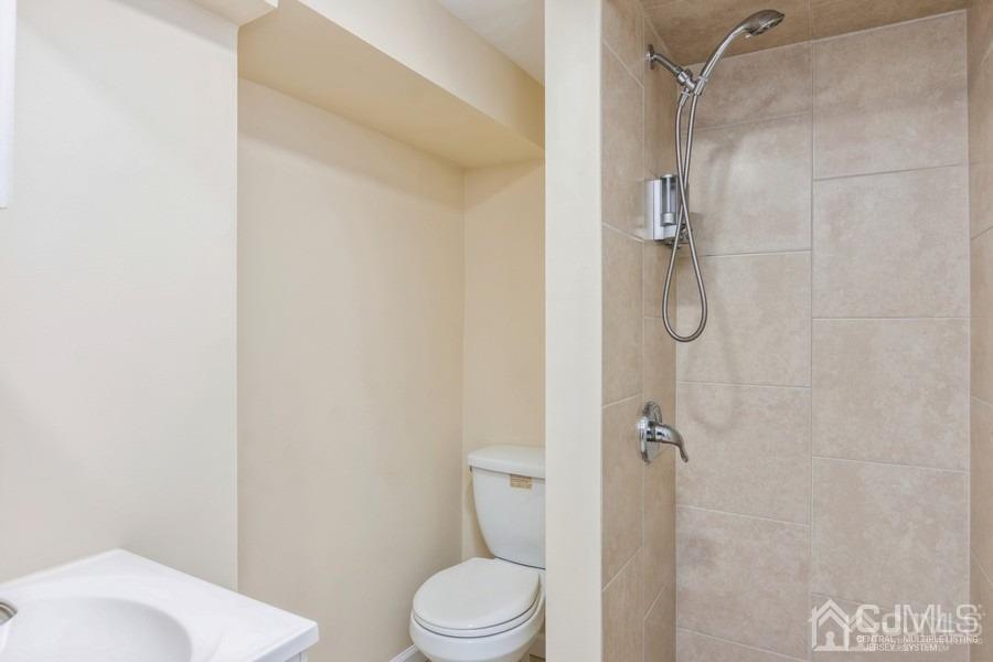 2 Colonial Road Roselle, NJ 07203 - Photo 16 of 17 a white toilet sitting next to a bathroom sink