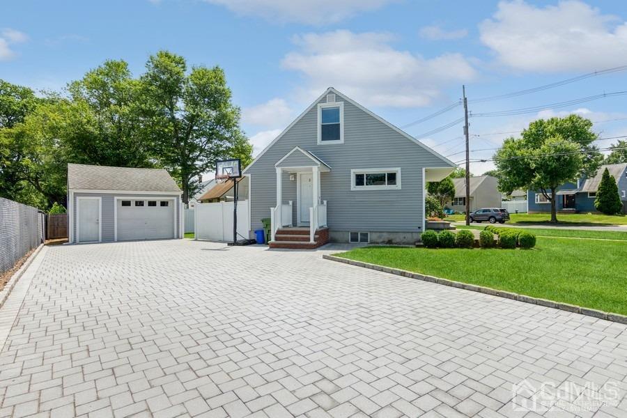 2 Colonial Road Roselle, NJ 07203 - Photo 2 of 17 a front view of a house with a yard and garage