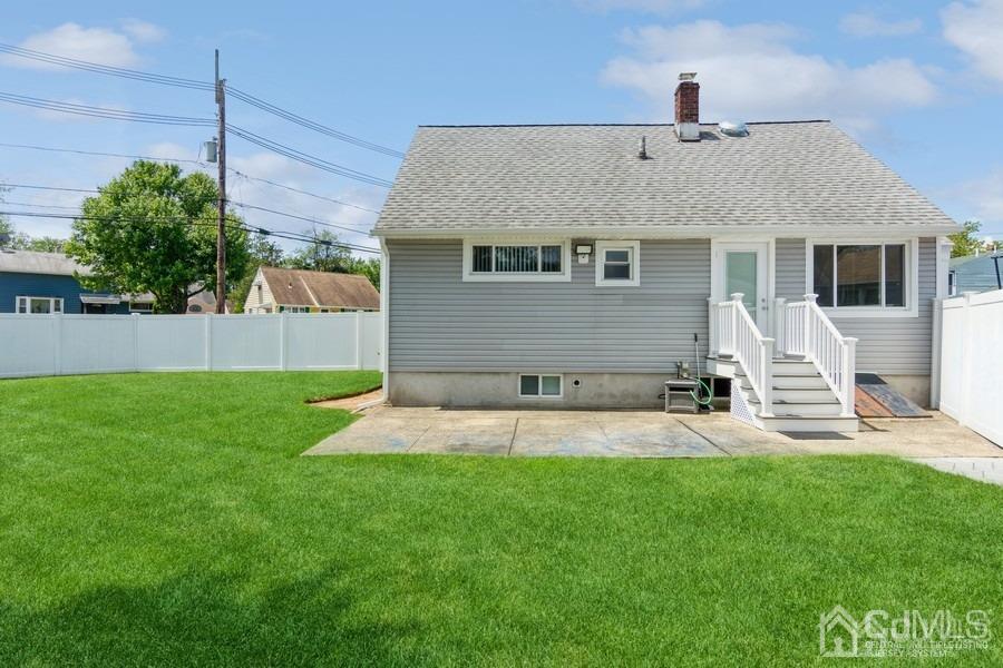 2 Colonial Road Roselle, NJ 07203 - Photo 4 of 17 a front view of a house with a yard and garage