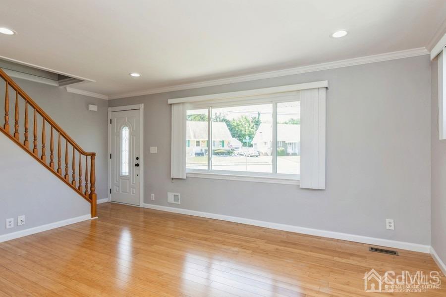 2 Colonial Road Roselle, NJ 07203 - Photo 6 of 17 a view of an empty room with wooden floor and a window