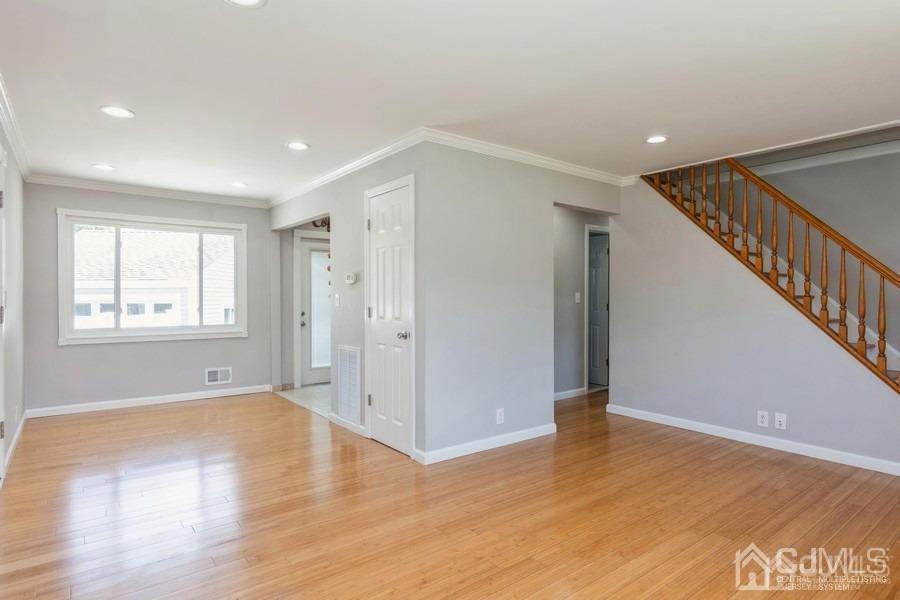 2 Colonial Road Roselle, NJ 07203 - Photo 7 of 17 a view of an empty room with wooden floor and a window