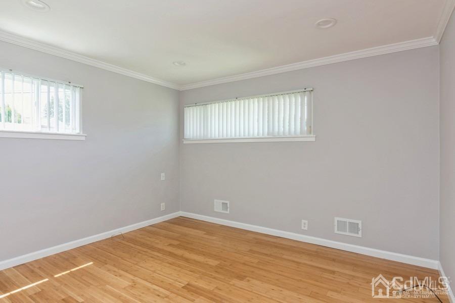 2 Colonial Road Roselle, NJ 07203 - Photo 9 of 17 a view of an empty room with wooden floor and a window