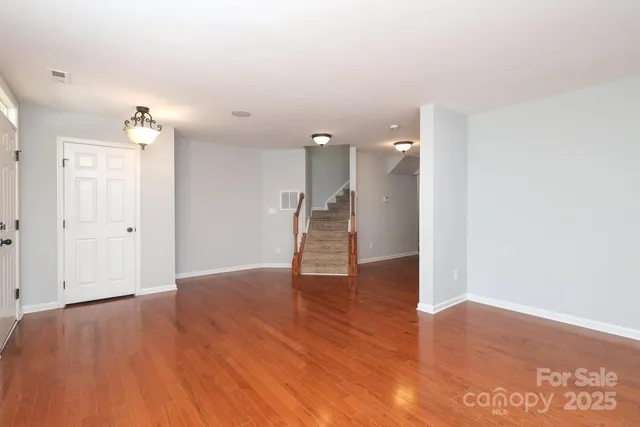 a view of a room with wooden floor and window