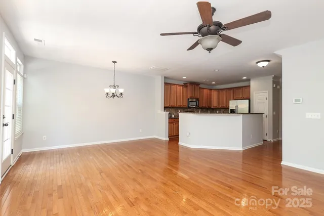 a view of a kitchen with a sink and wooden floor