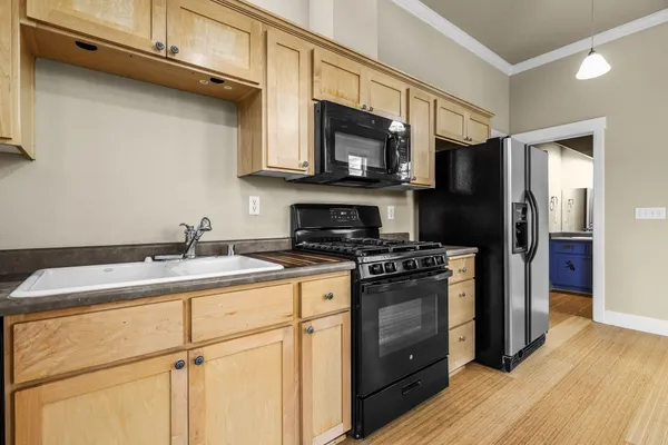 a kitchen with a sink stove and microwave