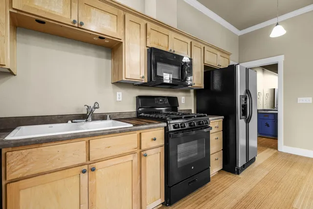 a kitchen with a sink stove and microwave