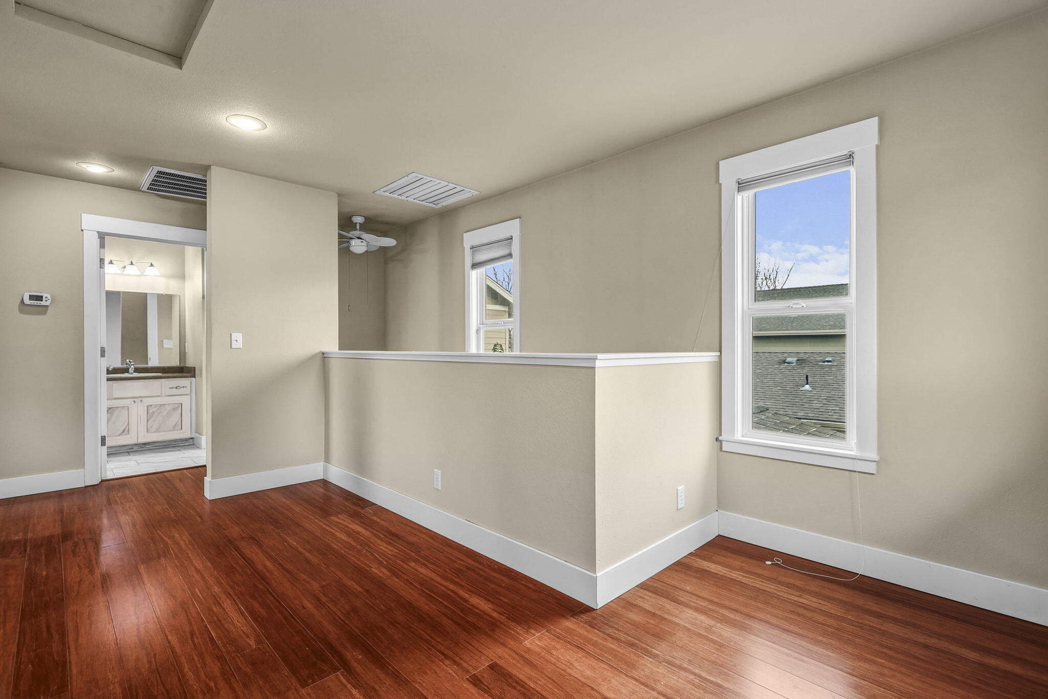 864 Kite Lane Redding, CA 96001 - Photo 4 of 18 a view of an empty room with wooden floor and a window