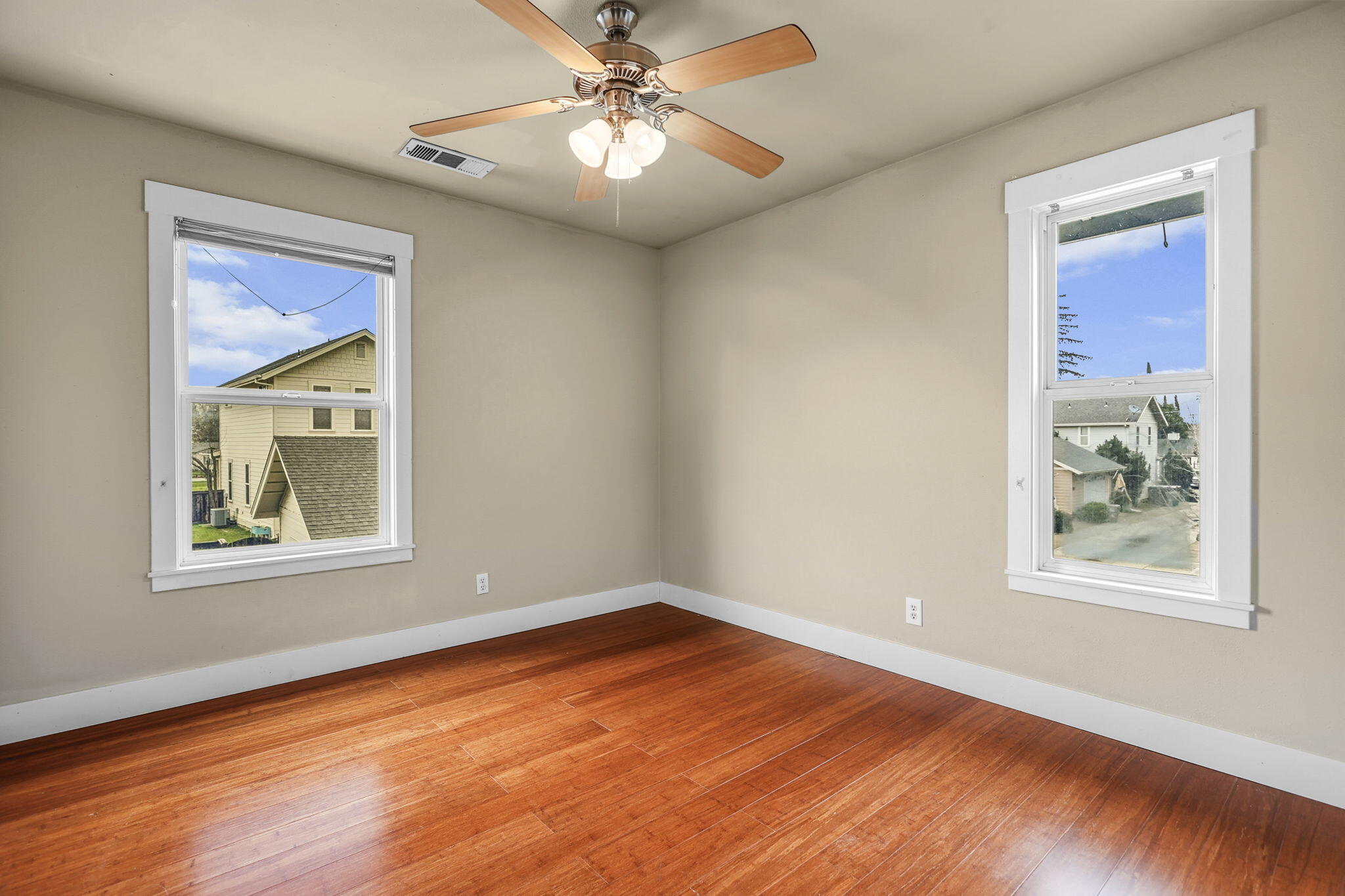 864 Kite Lane Redding, CA 96001 - Photo 9 of 18 a view of an empty room with wooden floor and a window