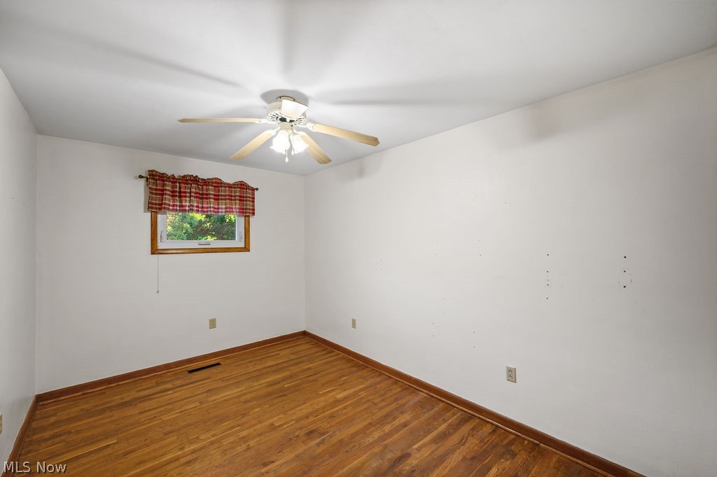 11363 Dupont Road Washington, WV 26181 - Photo 17 of 42 Wood flooring, single window with wood trim, ceiling fan with light fixture