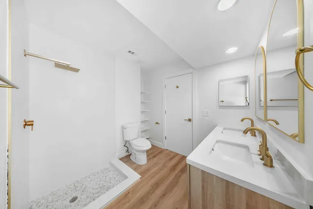 a bathroom with a sink toilet and shower