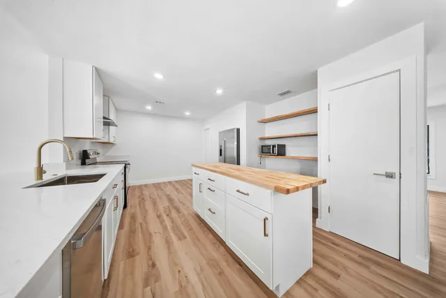 a kitchen with a sink stove and cabinets
