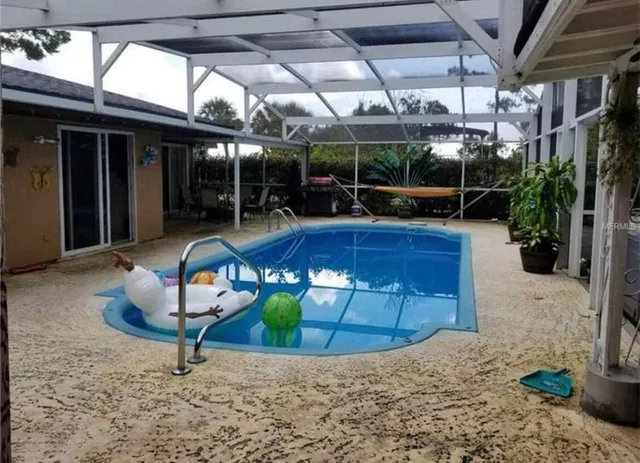 a view of a swimming pool with a patio