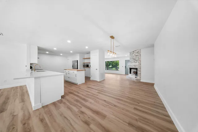 a view of kitchen and hall with wooden floor