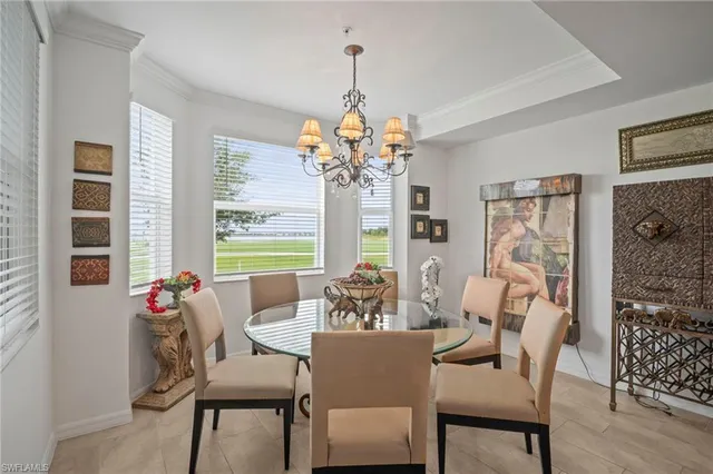 a dining room with furniture a chandelier and wooden floor