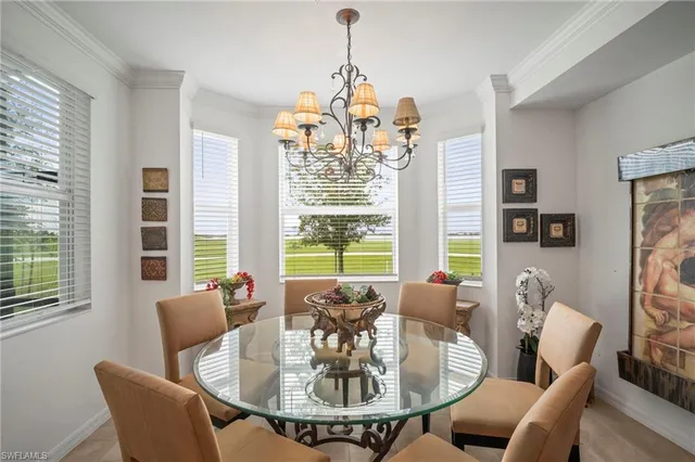 a kitchen with stainless steel appliances kitchen island granite countertop a sink dishwasher a refrigerator and white cabinets with wooden floor