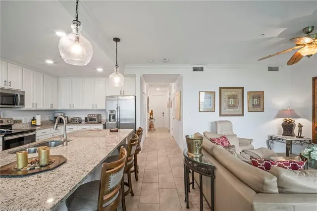 a bedroom with two beds and a chandelier