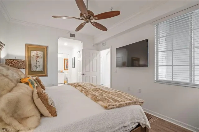 a bedroom with a large bed and a chandelier