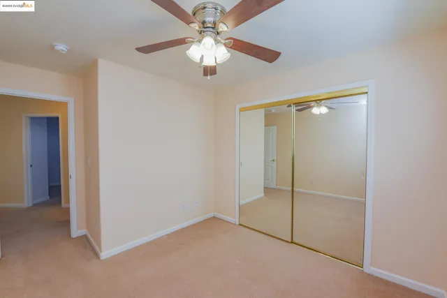 a view of an empty room with a fan