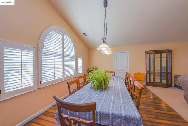 a view of a dining room with furniture and wooden floor