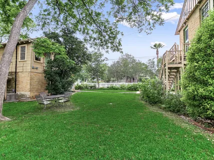 a view of a house with a backyard