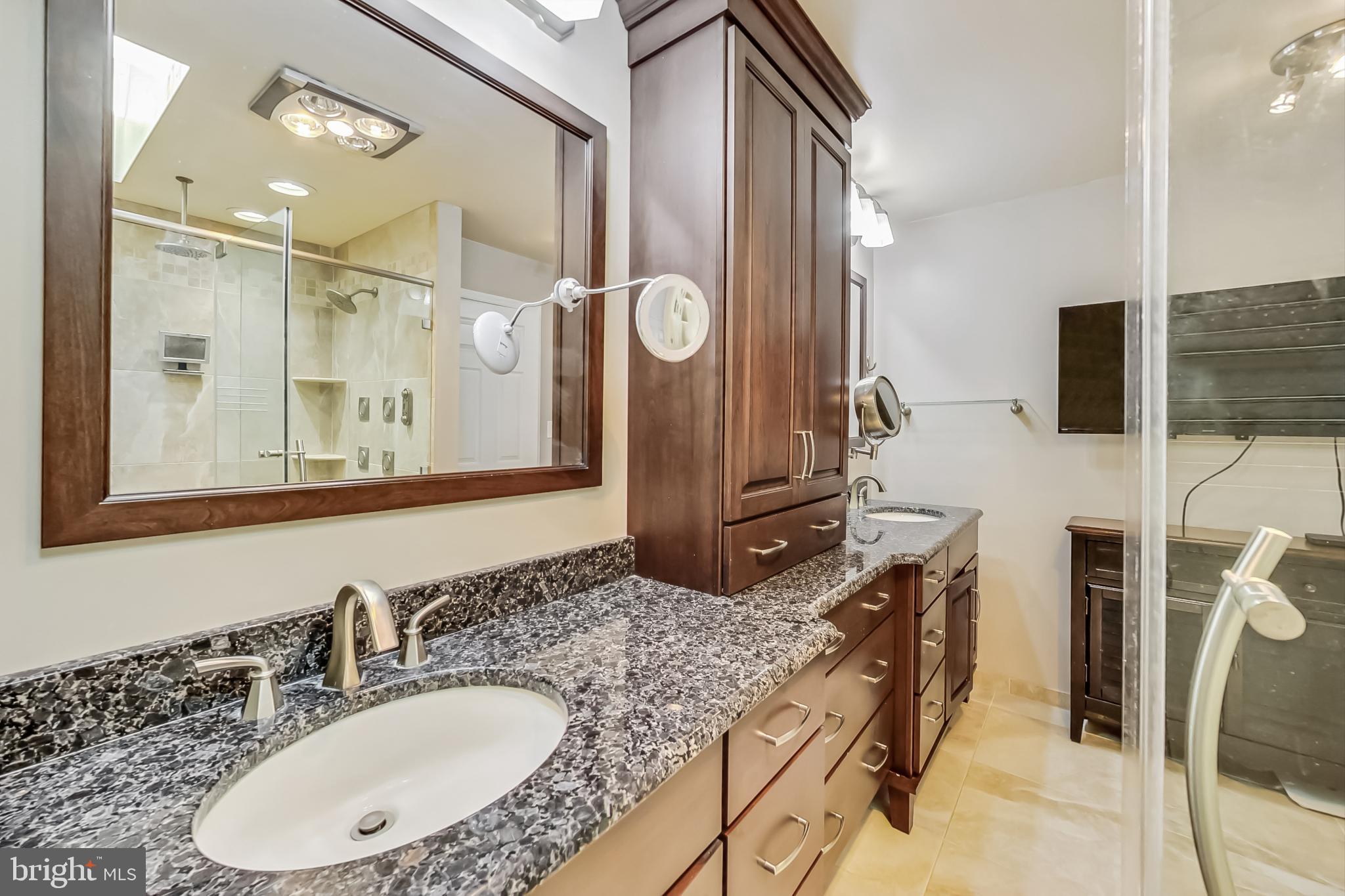 14611 Manor Road Phoenix, MD 21131 - Photo 37 of 85 a bathroom with a granite countertop sink a mirror a vanity and a shower