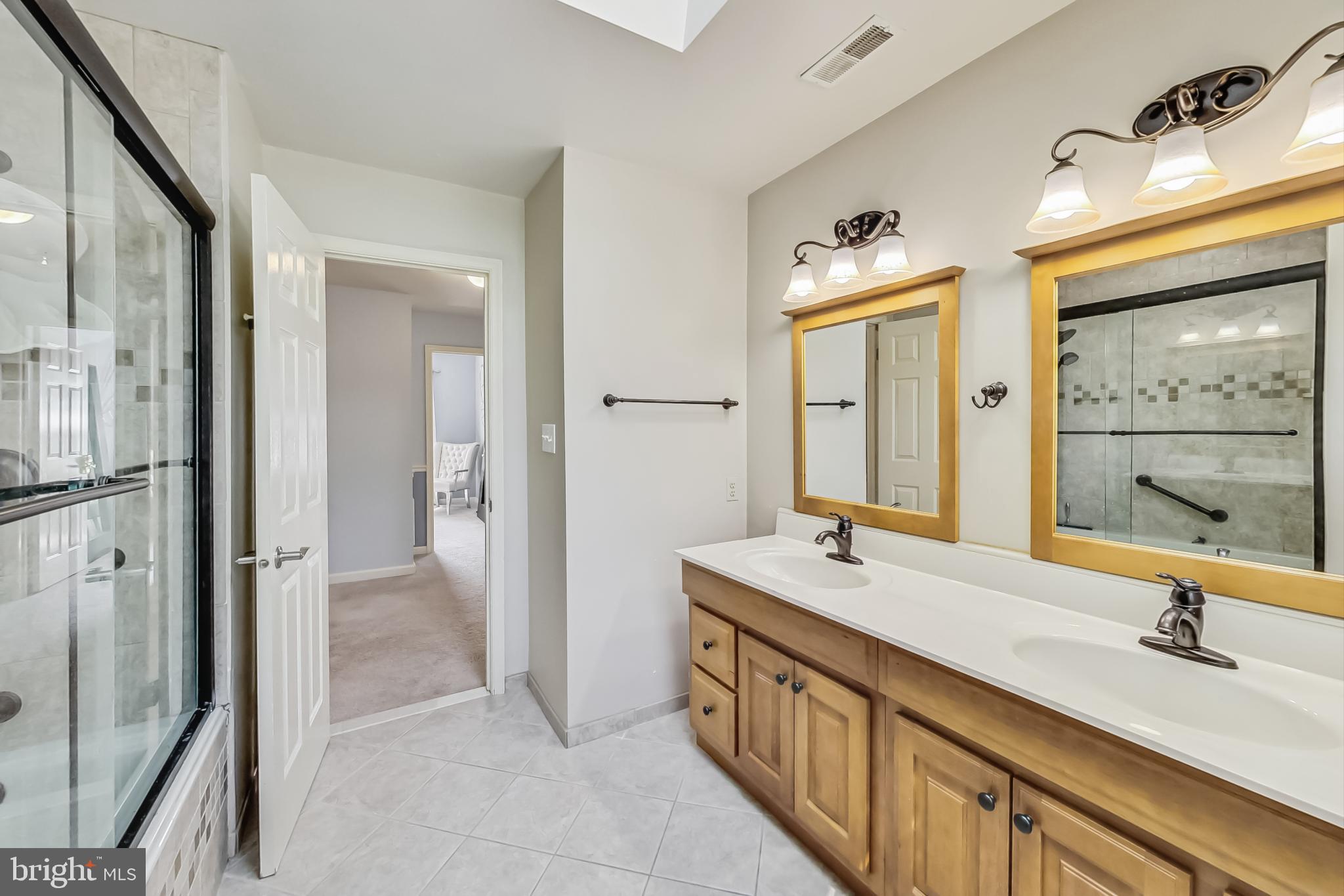 14611 Manor Road Phoenix, MD 21131 - Photo 46 of 85 a bathroom with a double vanity sink a mirror and a shower